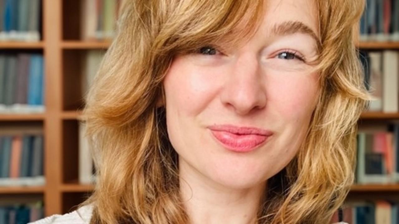 Headshot of Krista Williams in front of a bookshelf